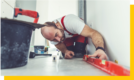 bathroom fitter checking floor level