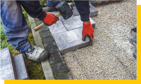 paving contractor laying patio stones