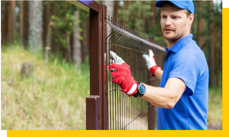 fencing contractor installing wire fence
