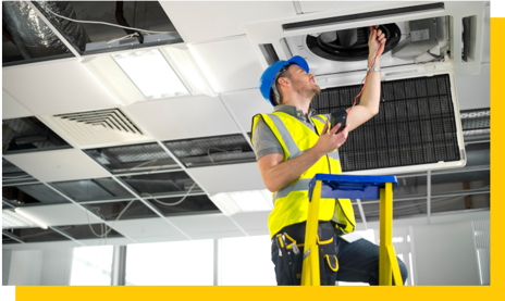 hvac engineer installing ceiling unit